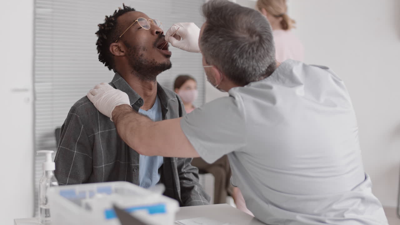 Nurse Taking DNA Sample from Man