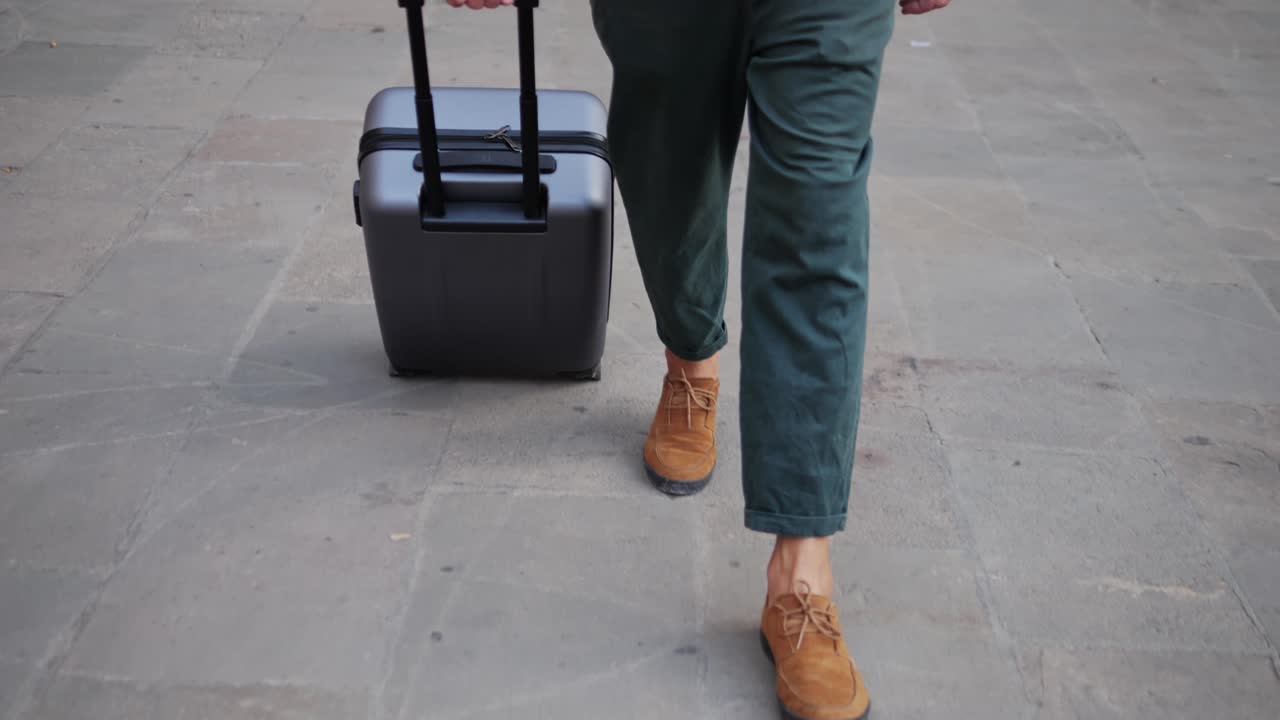 Man Walking with Suitcase on a Street
