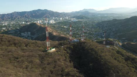 Drone-pans-across-the-valley-of-Santa-Marta-to-reveal-the-distant-city-along-the-coast-in-Colombia