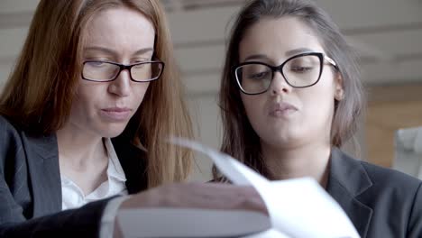 serious businesswomen working with papers