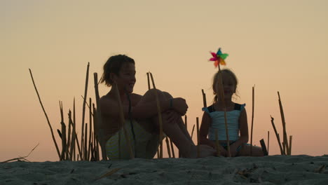 siblings constructing bamboo enclosure at sunset