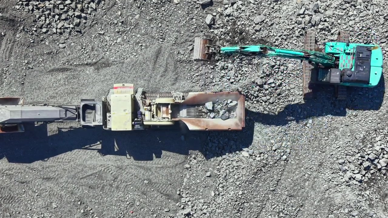 Granite quarry operation with heavy machinery extracting stone materials