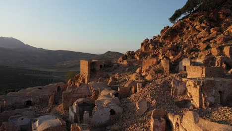 drone shot moving slowly forward over the ancient village in tunisia during a warm sunset