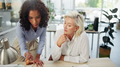 two businesswomen working together at the office