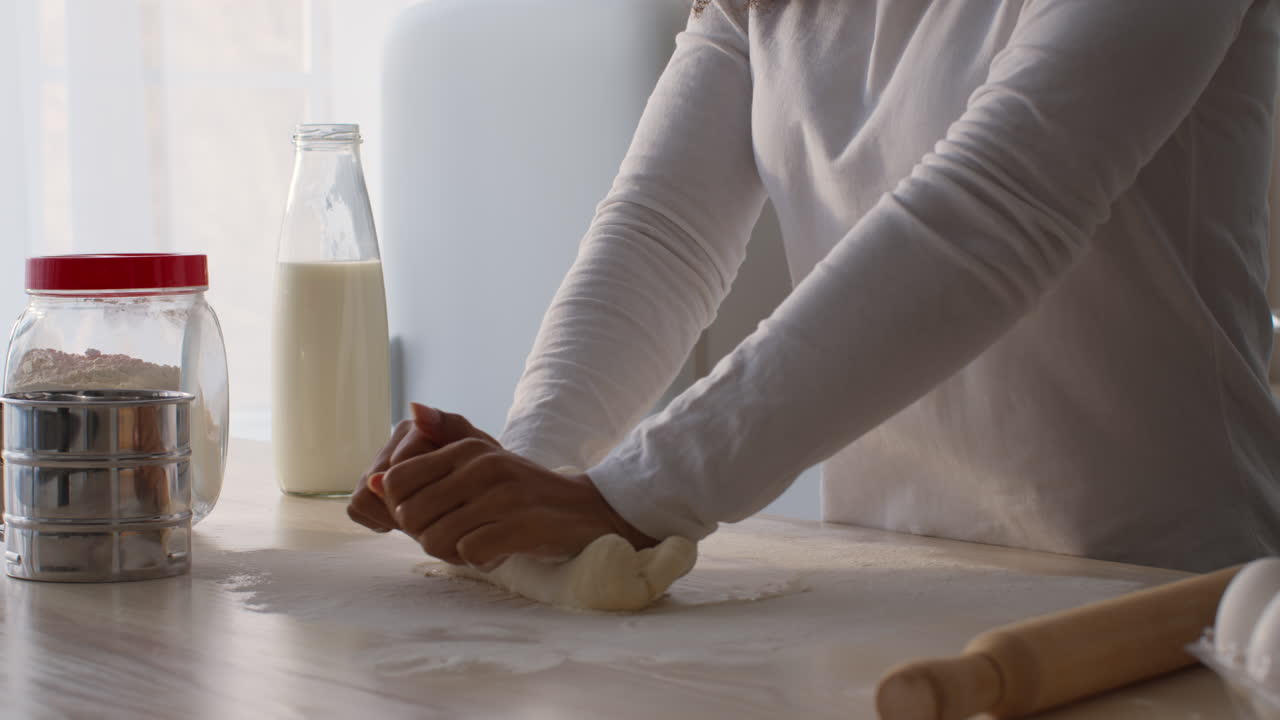 Woman Kneading Dough in Kitchen