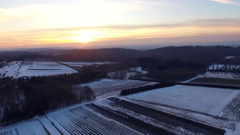 high flight above winter fields at sunset