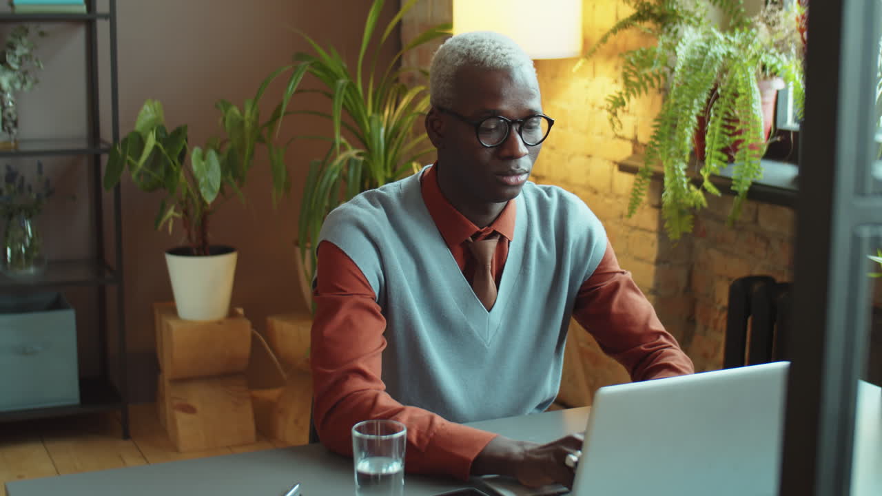 African American Businessman Working on Laptop at Office Desk