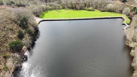 Aerial-forward-shot-over-Squabmoor-Reservoir-Woodbury-Common-Devon-England