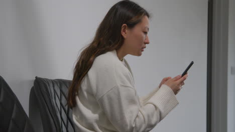 Stressed-Or-Anxious-Woman-At-Work-In-Office-Building-Reacting-To-Internet-Or-Social-Media-News-Message-Or-Story-On-Mobile-Phone-3