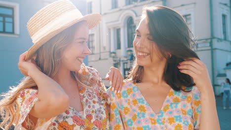 two happy women enjoying a sunny day in the city