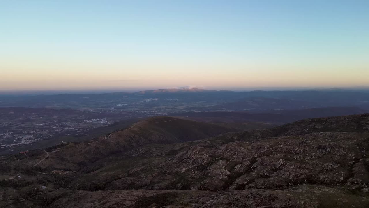 A vibrant sunset and a colorful horizon atop Portugal's highest peak in the Serra de Estrella mountain range