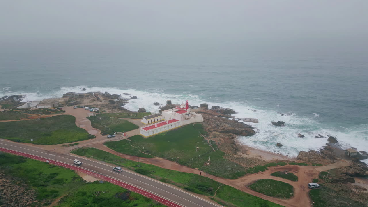 Panoramic seascape lighthouse standing rocky seashore aerial view. Foamy water
