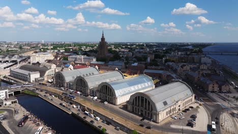 drone orbits above riga central market in latvian capital city in summer