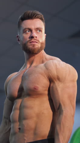 bodybuilding man training his biceps. young muscular man training hard at the gym. vertical video