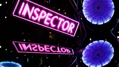 letreros de neón rosados que dicen "inspector"