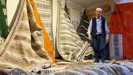 moroccan artisan showcases handmade carpets and rugs