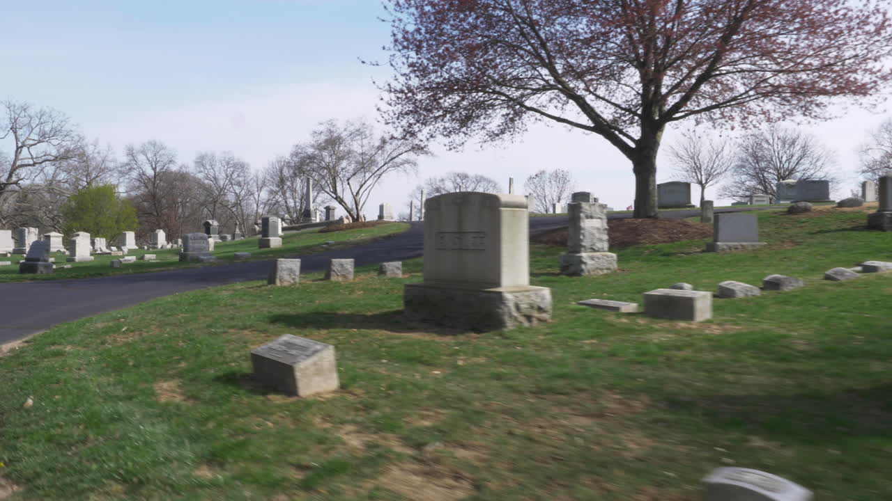 4K: Driving slowly by old headstones through a cemetery on a beautiful day