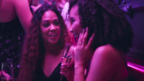 women laughing at a nightclub