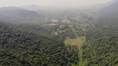 Looking-down-at-the-Highway-from-far-above-a-forested-hillside-at-midday-filled-with-lush-greens