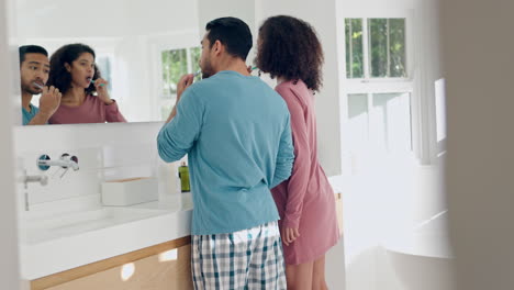 Bathroom,-mirror-and-talking-couple-brush-teeth