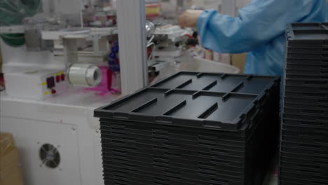 worker working at a machine-made press-on nail printing facility