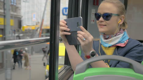 Woman-traveling-in-city-by-double-decker-bus