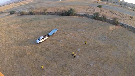 operators of the balloon company prepare the landing of a balloon in cappadocia