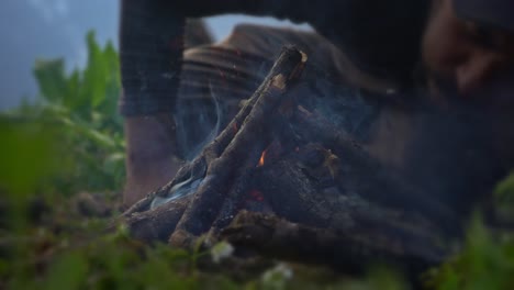 set campfire was blew by a man on misty morning in manali, himachal pradesh india. - dolly shot
