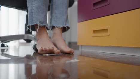 barefoot woman's legs and feet in office
