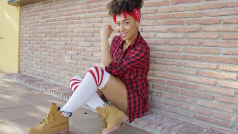 thoughtful chic young woman sitting on the ground