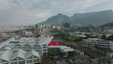 Backwards-fly-above-shopping-and-entertainment-centre.-Complex-of-buildings-in-Victoria-and-Alfred-Waterfront.-Cape-Town,-South-Africa