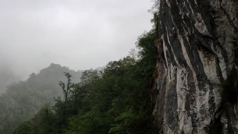 foggy cliffside view near sanctuary of covadonga, asturias, in lush green mountains