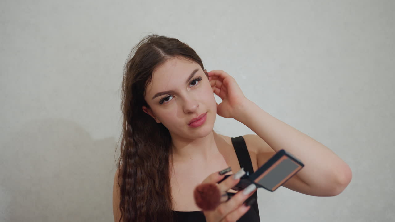 Makeup Routine Details, Nighttime Makeup Preparation Description, Young Woman Enhancing Her Look For Evening, Woman With Curly Brown Hair Adjusting Her Makeup For Stylish Evening Event