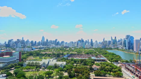 queen sirikit national convention centre construction site near benjakitti park and lake, millenium residence apartment, cti tower, ocean tower in bangkok, thailand on sunny day time-lapse