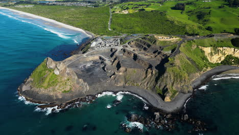 blue pacific ocean and quarry in new zealand, aerial drone view