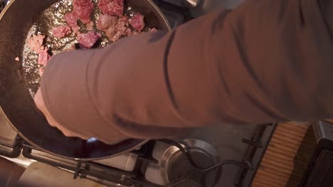 cook using spatula, stirring mince beef frying in hot oil on gas hob top down