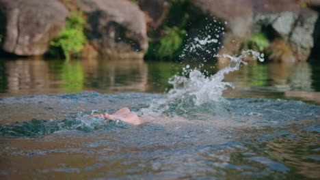 girl takes a swim in a lake slow motion