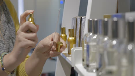 Woman-Testing-Perfume-With-A-Paper-Tester