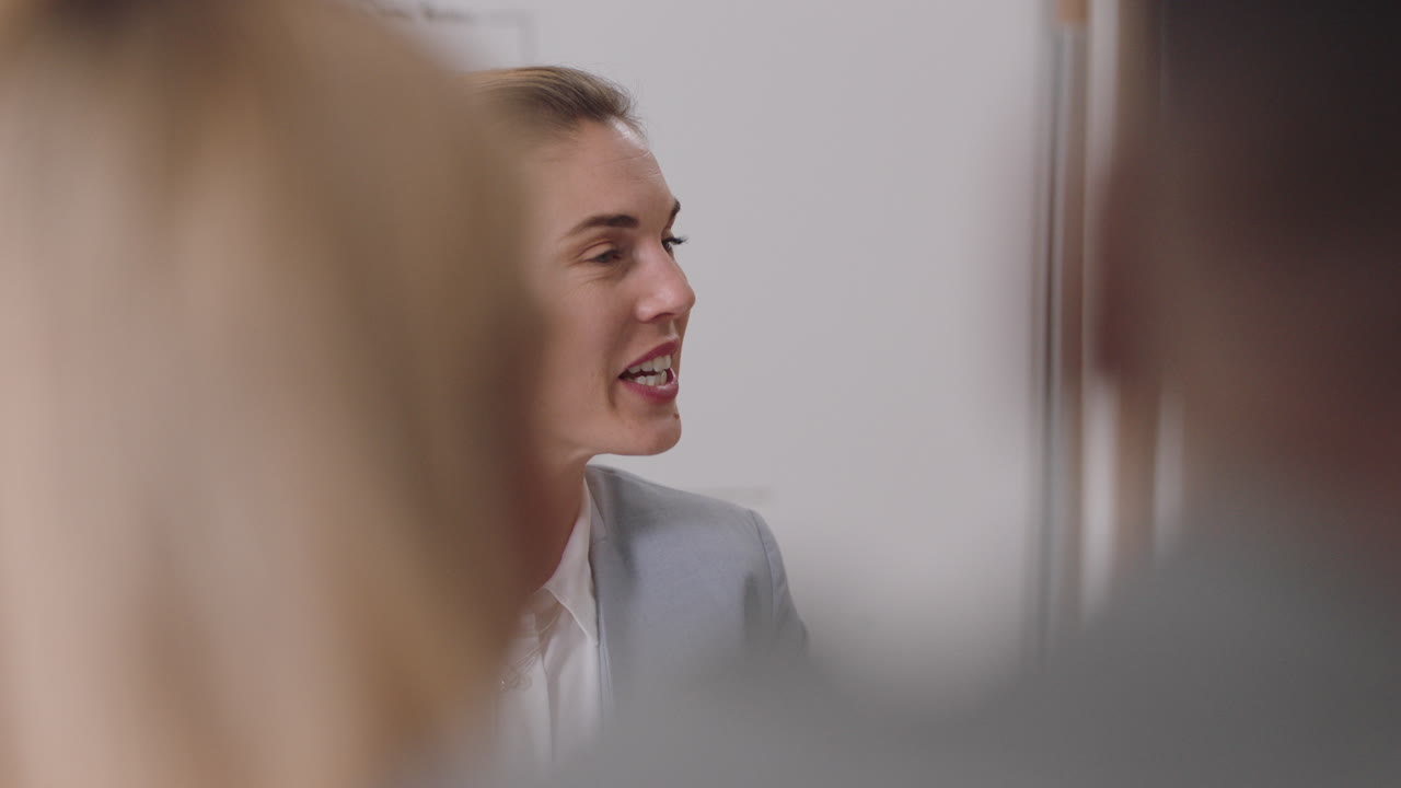 happy business woman team leader meeting with colleagues sharing creative ideas for startup project discussing corporate strategy in office boardroom
