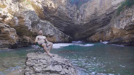 lonely young man camping at sea.