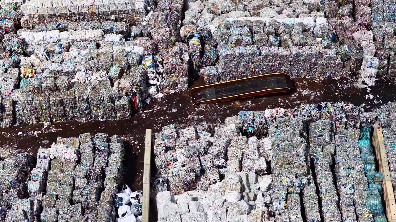 Huge landfill with sorted and compressed paper for recycling in aerial view