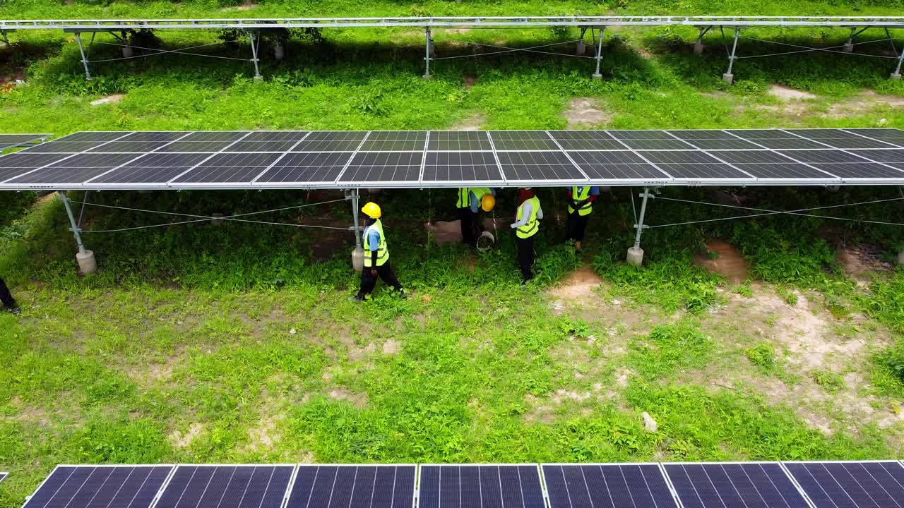 Aerial low sliding view of female technicians working at solar park in Jambur, Gambia