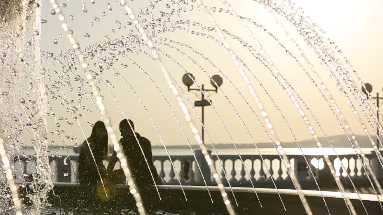 Silhouette of loving couple. Silhouette of young couple in love enjoying good time together during sunset