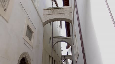 flying buttresses over an alleyway of spoleto in umbria