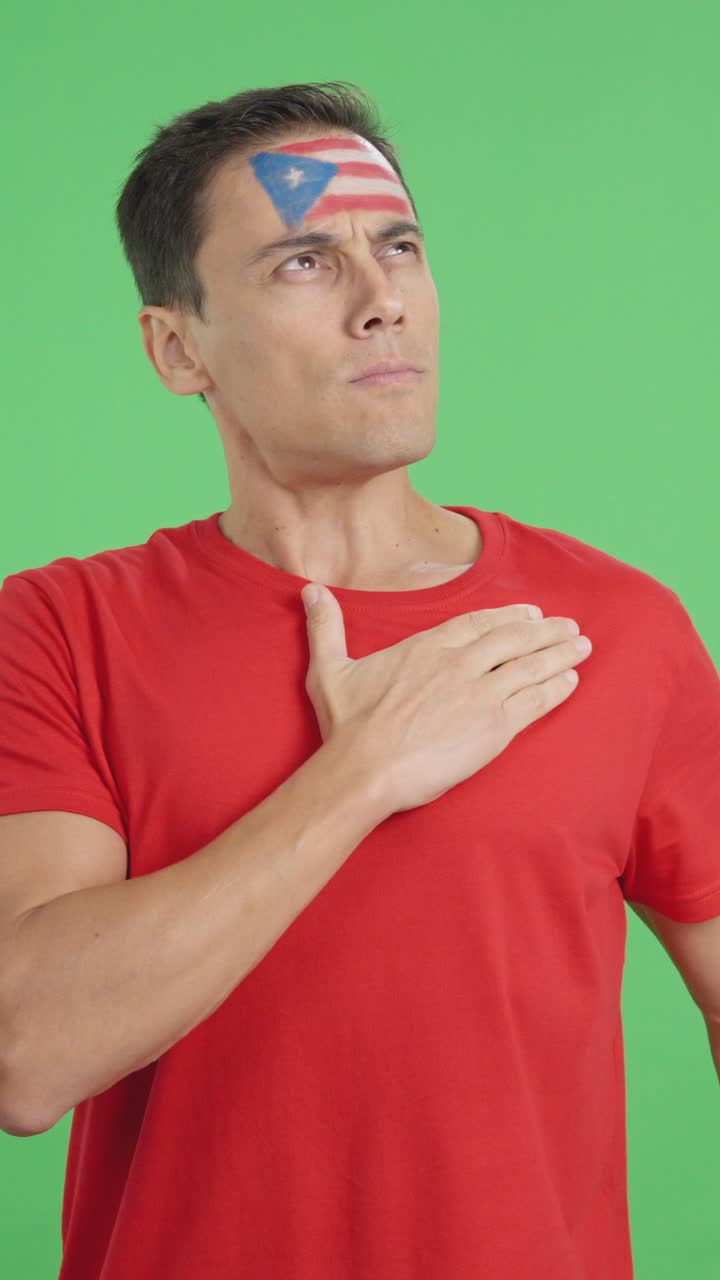 Man listening to the Puerto Rico national anthem with solemnity