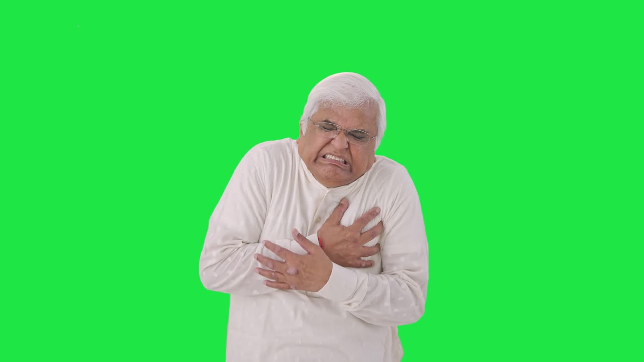 Sick Indian old man having a heart attack Green screen
