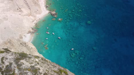 pleasure boats anchored at mizithres cliff rock in zakynthos ionian island, greece