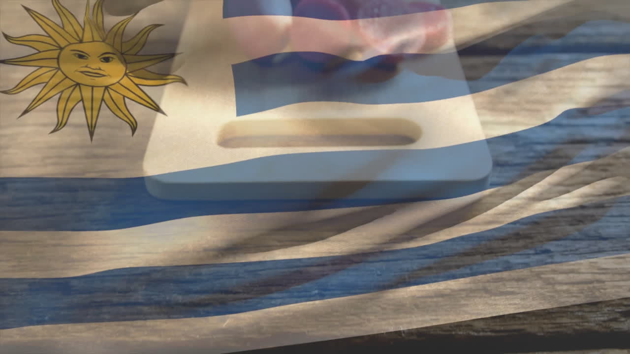 Uruguay flag animation overlaying wooden board with sliced fruits on rustic table