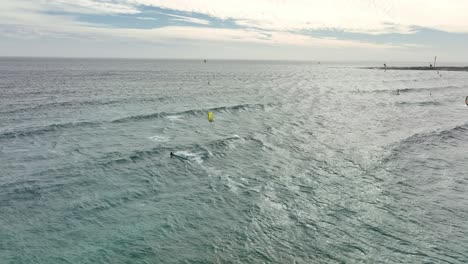 people kite surfing at misty cliff near cape town
