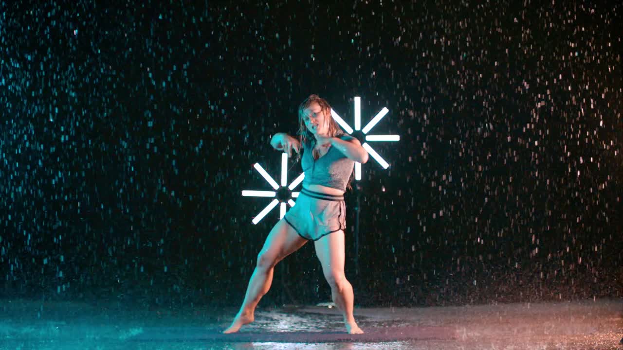 Female caucasian young dancer, contemporary dance moves, indoor rain effect